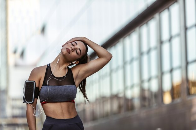 Beautiful sportive girl stretching her neck