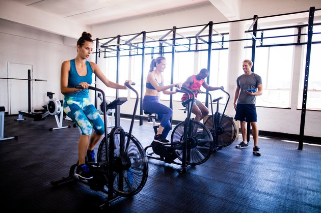 Multi-ethinc friends on indoor cycling during a gym training class