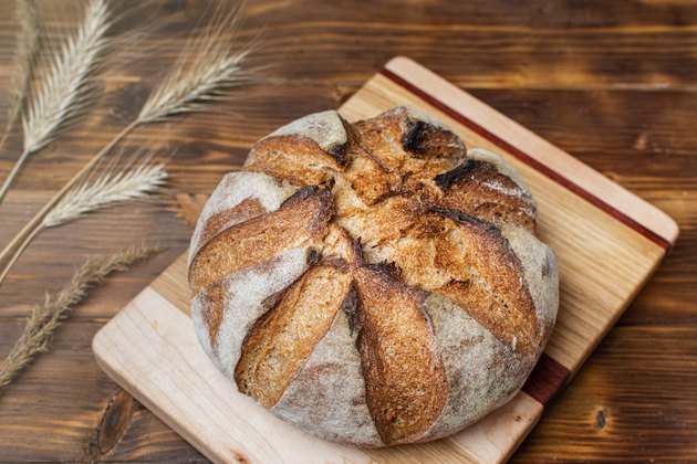 Close up of homemade whole grain sourdough bread on dark background