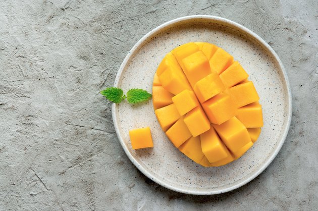 Sliced mango fruit on plate.