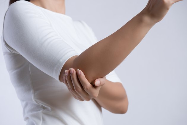 Closeup female's elbow. Arm pain and injury. Health care and medical concept.
