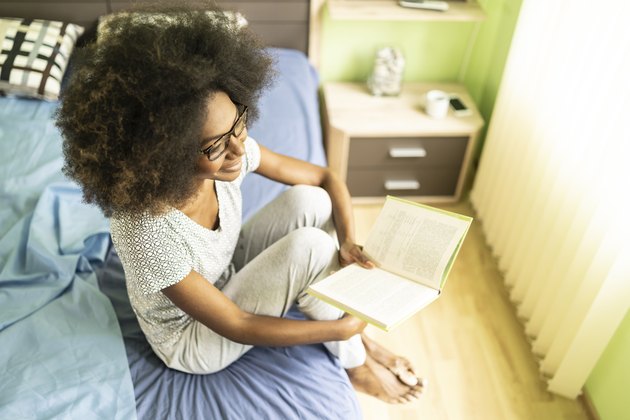 Afro woman reading book