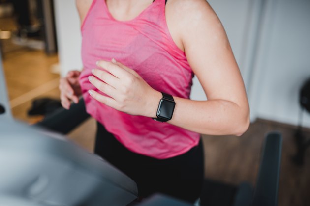 Young woman running on the treadmill in the gym