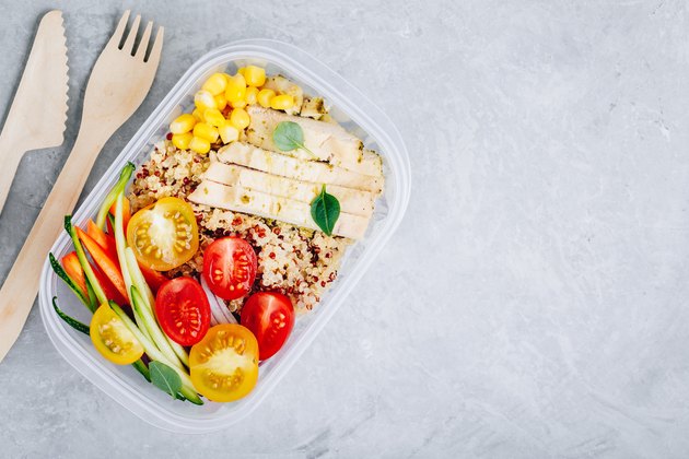 Meal prep containers with quinoa, fresh vegetables and chicken