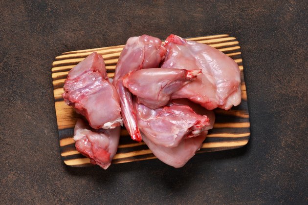Fresh, raw rabbit meat on a concrete background. Organic food.