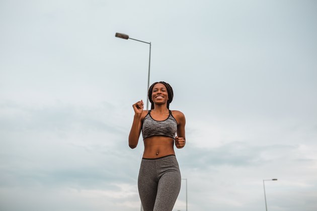 Healthy young african american woman running in urban environment