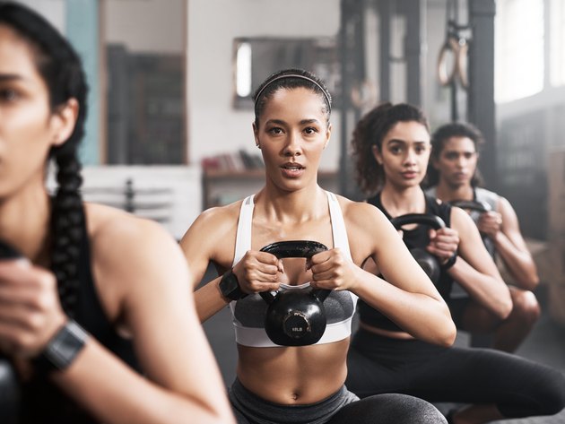 Women in a kettlebell class, trying to avoid making form mistakes