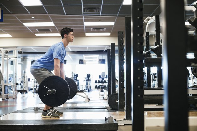 Man doing deadlifts in a gym