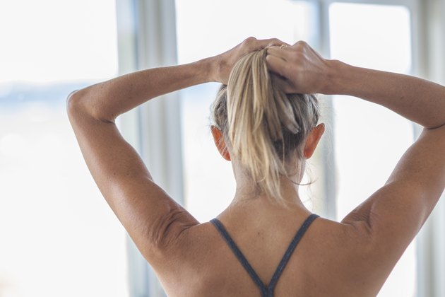 Woman Putting Hair In Pony Tail