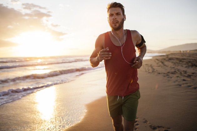 Young man running at the beach