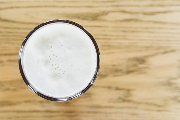 One pint of beer on wooden counter