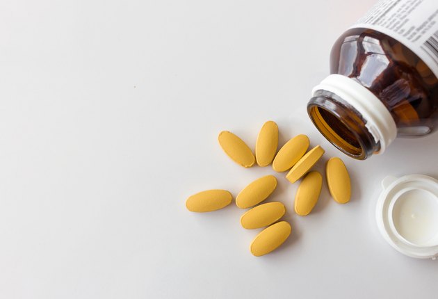 closeup vitamin C tablets on white table with soft-focus and over light background