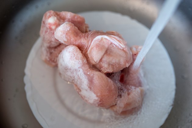 Defrost the frozen chicken under the water