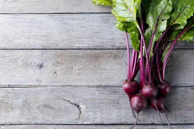 Fresh organic beet, beetroot on grey rustic wooden background. Top view. Copy space.