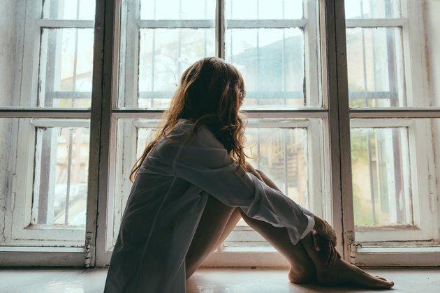 Woman Looking Through Window