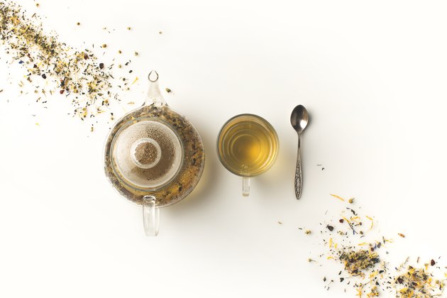 herbal tea in cup and kettle