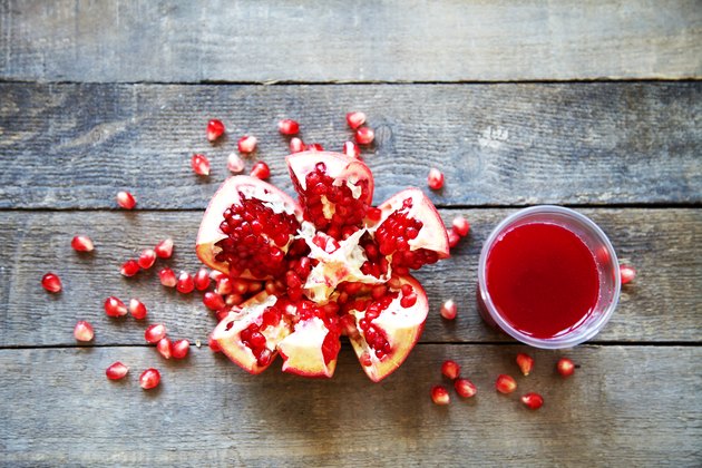 Ripe pomegranate fruit on wooden vintage background