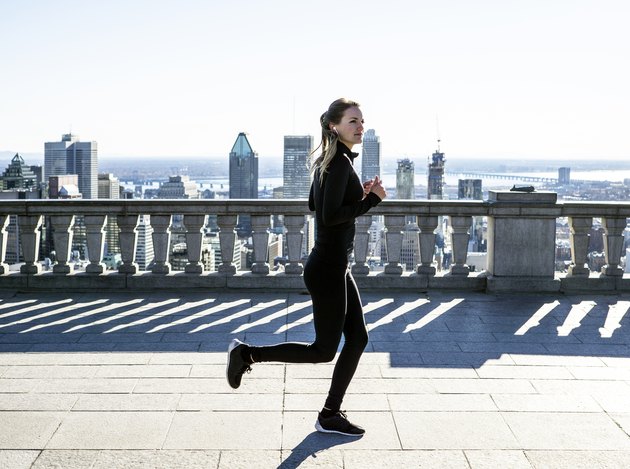 Caucasian woman running in city