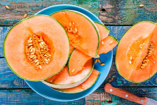 Foods high in potassium like melon on a plate on a rustic background