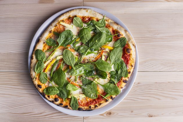 Close up of pizza with fresh spinach