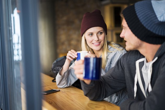 Hiking couple having coffee in restaurant