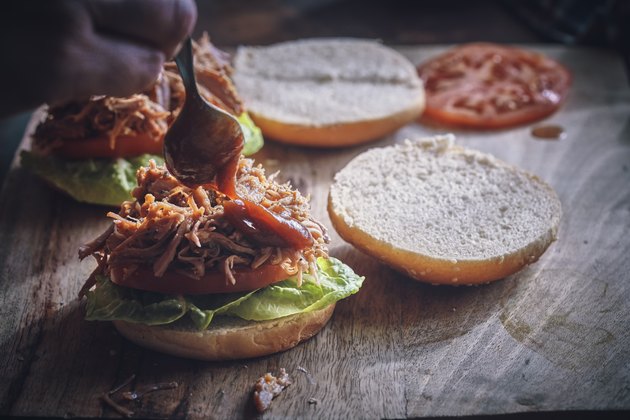 Pulled pork sandwich with tomato, lettuce and gluten-free BBQ sauce