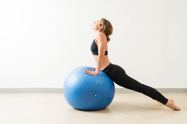 Side View Of Young Woman Stretching During Workout