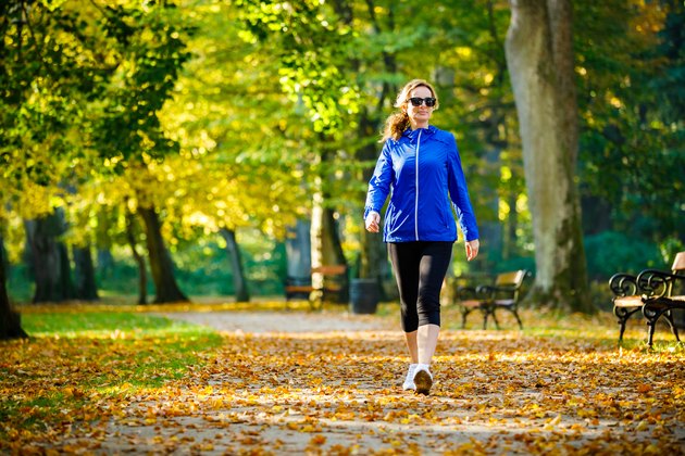 A middle-aged woman walking in the park for exercise