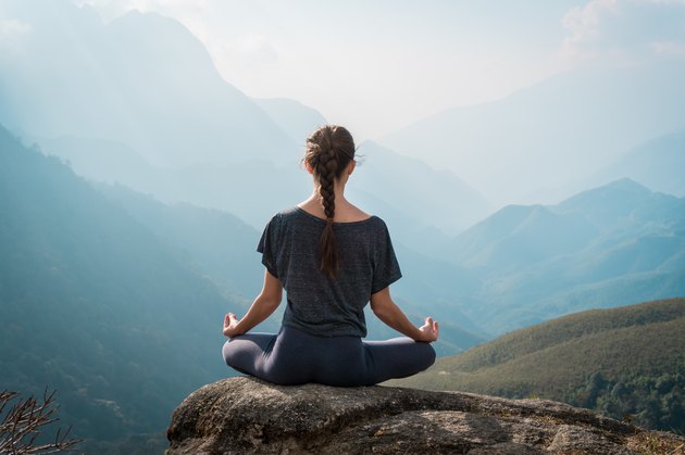 Woman meditates in yoga asana Padmasana