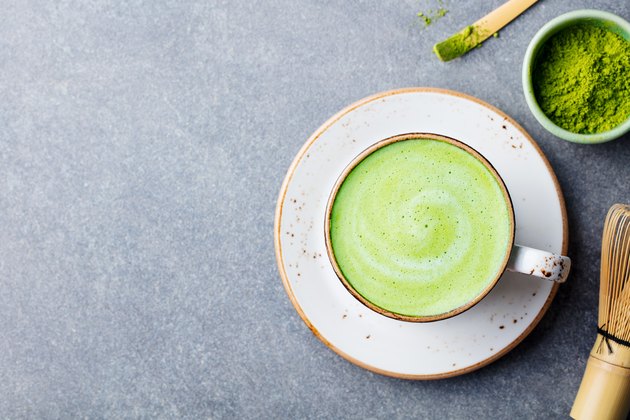 Matcha green tea latte in a cup. Top view. Copy space.