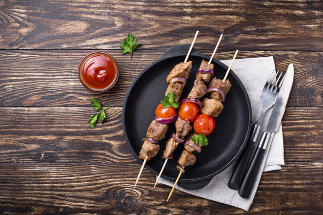 Grilled shish kebab skewers with tomatoes