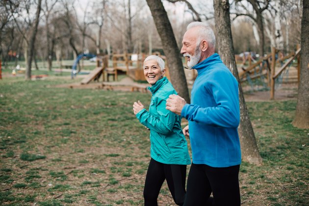 Senior couple wearing sport clothes jogging at the park