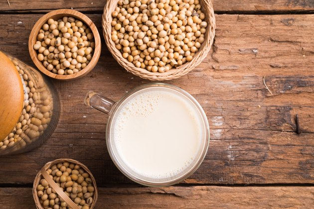 Glass with Soy Milk and Seeds on background