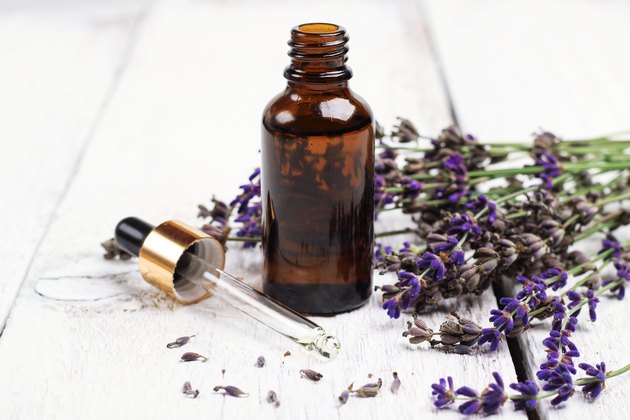 Dry lavender and oil on a white wooden table