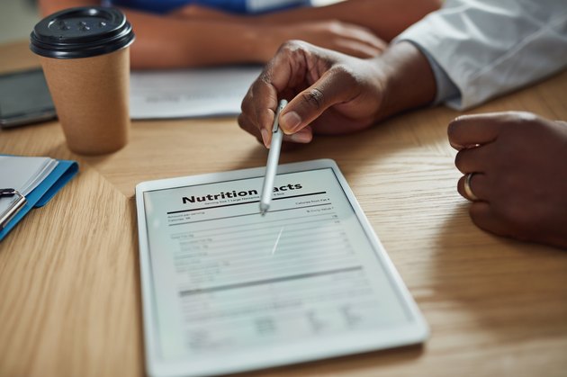 Dietitian's hand pointing to nutrition facts label on an iPad