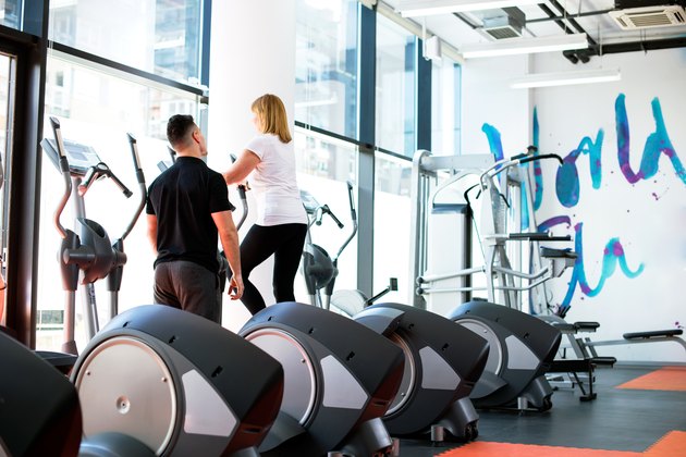Mature woman with personal trainer