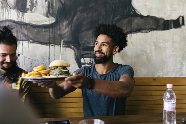 Customer Receiving Food At Burger Restaurant