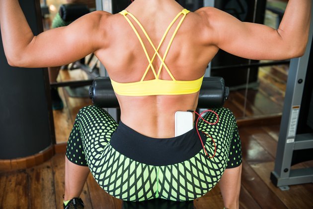 Woman on lat machine