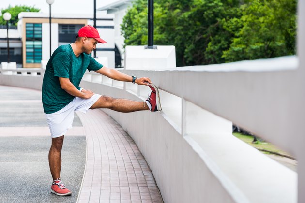 Young asian man doing static stretching for hamstring