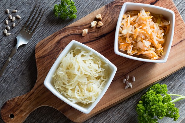 Fermented cabbage and a mix of fermented cabbage with carrots in two square bowls