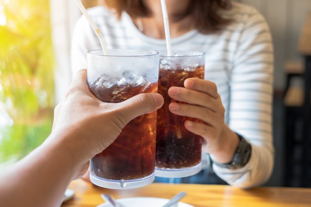 Men and Woman hand giving glass of cola