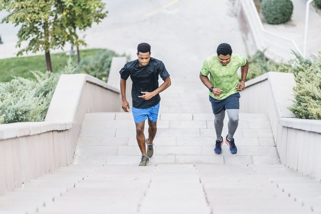 Two sportsmen runnning up steps