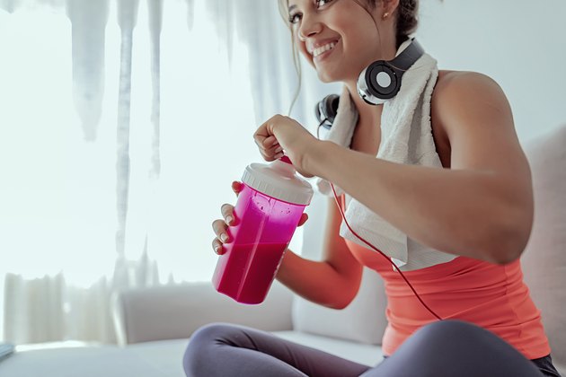 A female drinking a shake made with protein powder for her weight-loss diet