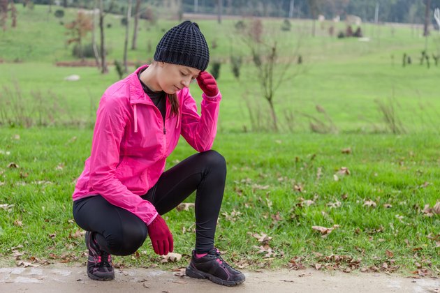 Young female athlete feeling lightheaded or with headache