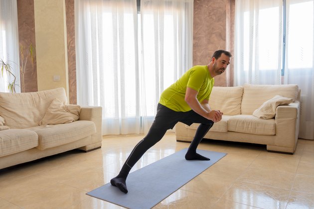Man performing lateral lunge.