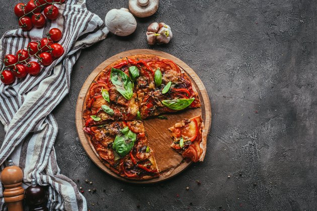 top view of delicious freshly baked pizza on concrete table