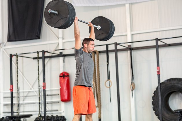 Man weightlifting barbell in gym