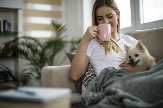 Woman relaxing at home with her dog