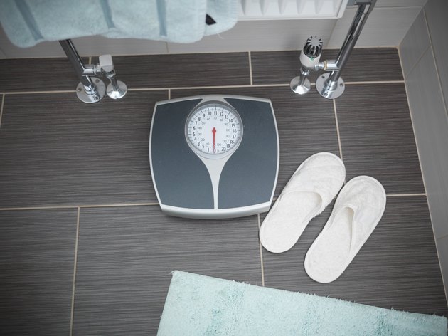 Scales and slippers in senior person's bathroom