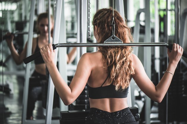 Young Woman Using Exercise Machine
